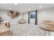 Finished basement area featuring a patterned rug, beanbag chairs, and a window at 600 Vine St, Denver, CO 80206