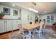 Bright dining room featuring hardwood floors, stylish lighting, and built-in cabinetry at 600 Vine St, Denver, CO 80206