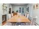 Well-lit dining room with a large wooden table, six chairs, and a view of the outdoors at 600 Vine St, Denver, CO 80206