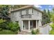 Stunning two-story home with gray stucco, clay tile roof, front porch, and second story balcony at 600 Vine St, Denver, CO 80206