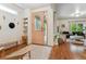 Foyer view includes a decorative mirror, bench, and the front door adjacent to the living room at 600 Vine St, Denver, CO 80206