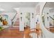 Inviting foyer features a staircase with a pink riser and a view into the guest bathroom at 600 Vine St, Denver, CO 80206