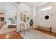 Foyer with wood floors, arched doorways, a large round mirror, and built-in storage shelves at 600 Vine St, Denver, CO 80206