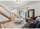 Cozy living room with fireplace, hardwood floors, a large window, and staircase to the second floor at 600 Vine St, Denver, CO 80206