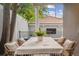 Charming outdoor patio with a table, chairs, and view of the backyard at 600 Vine St, Denver, CO 80206