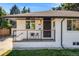 Charming ranch home with a white brick facade and well-manicured lawn at 6090 W 35Th Ave, Wheat Ridge, CO 80033