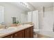 Bathroom featuring double sinks with white tile backsplash and a shower and tub combination at 1863 Rose Petal Ct, Castle Rock, CO 80109