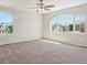 Sun-drenched bedroom boasts neutral walls and carpet and features arched windows with views of community at 1863 Rose Petal Ct, Castle Rock, CO 80109