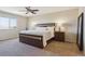 Bedroom featuring neutral walls and carpet, a dark wood bed frame, and a large window with a view at 1863 Rose Petal Ct, Castle Rock, CO 80109