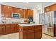 Modern kitchen with stainless steel appliances, tile backsplash, and center island at 1863 Rose Petal Ct, Castle Rock, CO 80109