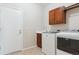 Functional laundry room with updated washer, dryer, and storage cabinets at 1863 Rose Petal Ct, Castle Rock, CO 80109