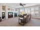 Cozy living room with fireplace, built-in shelves, neutral carpet, and large windows at 1863 Rose Petal Ct, Castle Rock, CO 80109