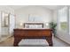 Spacious main bedroom featuring a sleigh bed, ensuite bathroom with sliding door, and a sun-drenched window at 1863 Rose Petal Ct, Castle Rock, CO 80109