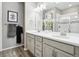 Elegant double vanity bathroom with a large mirror and shower at 9914 Truckee St, Commerce City, CO 80022