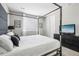 Spacious bedroom with a king-size bed, TV, and plenty of natural light at 9914 Truckee St, Commerce City, CO 80022