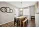 Light-filled dining area with a wood table and seating for six at 9914 Truckee St, Commerce City, CO 80022
