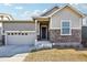 Attractive Craftsman style home with stone accents and a two-car garage at 9914 Truckee St, Commerce City, CO 80022