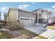 House exterior with a two-car garage and landscaping at 9914 Truckee St, Commerce City, CO 80022