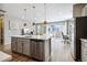 Modern kitchen with island, stainless steel appliances and open layout at 9914 Truckee St, Commerce City, CO 80022
