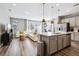 Open floor plan with modern kitchen, island, and spacious living room at 9914 Truckee St, Commerce City, CO 80022