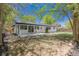 Large backyard with mature trees and a concrete patio, perfect for entertaining at 1486 S Kingston St, Aurora, CO 80012
