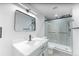 Modern bathroom featuring a glass-enclosed shower and sleek vanity at 1486 S Kingston St, Aurora, CO 80012
