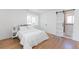 Bright bedroom with large window and a sliding barn door to the bathroom at 1486 S Kingston St, Aurora, CO 80012