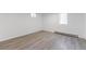 Well-lit bedroom featuring gray floors, white walls, and two windows at 1486 S Kingston St, Aurora, CO 80012