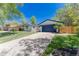 Charming home with blue trim, a garage, and a long driveway at 1486 S Kingston St, Aurora, CO 80012