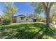 Well-maintained home with a green lawn and mature trees, showcasing curb appeal at 1486 S Kingston St, Aurora, CO 80012