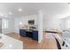 Bright open kitchen, modern cabinets with stainless appliances, seamlessly connects to living and dining spaces at 1486 S Kingston St, Aurora, CO 80012