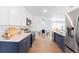 Modern kitchen features white cabinets, navy blue lowers, quartz countertops, and stainless steel appliances at 1486 S Kingston St, Aurora, CO 80012