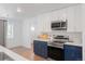 Well-lit kitchen features stainless steel appliances, quartz countertops, and modern cabinets for ample storage at 1486 S Kingston St, Aurora, CO 80012