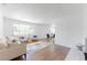 Bright living room with hardwood floors, modern furniture, and ample natural light from large windows at 1486 S Kingston St, Aurora, CO 80012