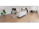 Open-concept living room boasts hardwood floors, modern decor, and seamless flow to kitchen and dining area at 1486 S Kingston St, Aurora, CO 80012