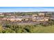 Aerial view showcasing a shopping center surrounded by trees, buildings, and parking at 2154 Concord Ln, Superior, CO 80027