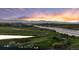 Aerial view of townhomes with lush greenery, lake views, and distant mountains at 2154 Concord Ln, Superior, CO 80027