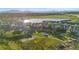 Aerial view of a neighborhood showcasing homes, green spaces, and a lake at 2154 Concord Ln, Superior, CO 80027
