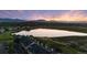 Scenic sunset aerial view of townhomes next to lake with mountain backdrop at 2154 Concord Ln, Superior, CO 80027