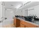 Well-lit bathroom featuring dual dark vessel sinks and a shower-tub combo at 2154 Concord Ln, Superior, CO 80027