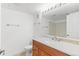 Bathroom featuring a single sink vanity, a large mirror, and a tiled shower at 2154 Concord Ln, Superior, CO 80027