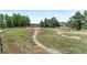 Outdoor bike park with dirt mounds and a paved path amidst lush green trees and vegetation at 2154 Concord Ln, Superior, CO 80027