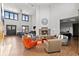 Spacious common room featuring a stone fireplace, ample seating, and floor-to-ceiling windows for natural light at 2154 Concord Ln, Superior, CO 80027