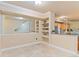 Open dining area with travertine floors, mirror accent wall, and display shelving, adjacent to the kitchen at 2154 Concord Ln, Superior, CO 80027