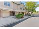 View of townhome exteriors with attached garages and landscaping along the street at 2154 Concord Ln, Superior, CO 80027