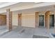 Covered garage entrance with brick pillars and a convenient doorway nearby at 2154 Concord Ln, Superior, CO 80027