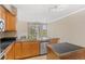 Kitchen area with stainless steel appliances and black countertops near a window and fireplace at 2154 Concord Ln, Superior, CO 80027