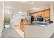 Open-concept kitchen and dining area featuring stainless steel appliances, black counters, and tile flooring at 2154 Concord Ln, Superior, CO 80027