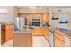 Kitchen featuring stainless steel appliances, black countertops, wood cabinets and travertine tile flooring at 2154 Concord Ln, Superior, CO 80027