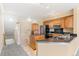 Bright kitchen featuring wood cabinetry, black countertops, and stainless steel appliances at 2154 Concord Ln, Superior, CO 80027